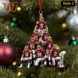 A pyramid formation of football players on a display base hanging before a Christmas tree.