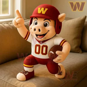 Washington Commenders Major Tuddy PLUSH PILLOW 3 Washington Commanders Major Tuddy plush pillow on a beige sofa near a sunlit window.