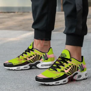 Alt text: A person is wearing neon green and pink Nike Air Max shoes with 