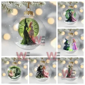 Clear ornament with two witches standing before a green clock on a snowy base.