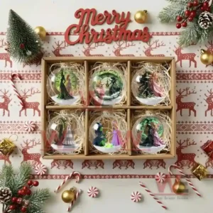 WICKED Christmas Ornament 10 Gift box with six clear ornaments showing winter scenes of two witches.
