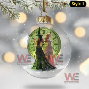 WICKED Christmas Ornament 12 Transparent ornament with two witches before a glowing green clock.