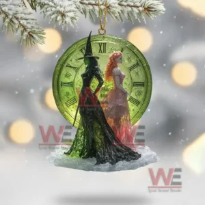 Clear ornament with two witches in front of a glowing green clock.