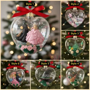 Heart shaped ornament featuring two witches standing together above decorative roses.