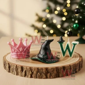 Candles shaped as a crown a witch hat and a letter W placed on a wooden slab in a festive room!