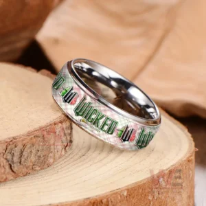 Silver ring on wood showing patterned band with repeating Wicked themed text!