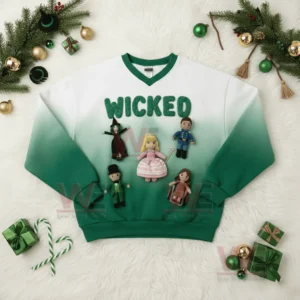 A green and white Wicked themed sweatshirt with crochet dolls displayed flat with holiday decorations nearby!
