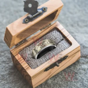 Silver ring with beige Winnie the Pooh themed band inside a wooden gift box!