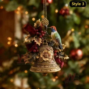 Colorful hummingbird ornament on floral bell with holly and ribbon before Christmas tree.