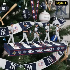 A New York Yankees themed ornament with several baseball figures displayed on a platform hanging on a decorated Christmas tree.