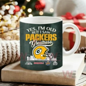 Dark green coffee mug with football team helmet and celebratory text displayed among holiday decor!