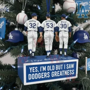 A close view of a Dodgers themed ornament hanging on a Christmas tree showing three uniformed figures arranged on a blue platform with festive lights and team decorations!