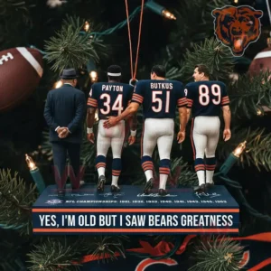 A close view of a hanging ornament on a Christmas tree depicting four uniformed Bears figures standing on a base with text about witnessing the greatness of the team.