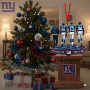 Four Giants figures on a round ornament base hanging in front of a Christmas tree decorated in team colors.