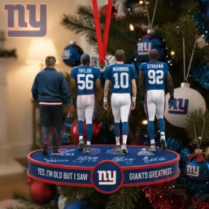 A coach and three Giants players standing on a circular ornament base in front of a team themed Christmas tree.