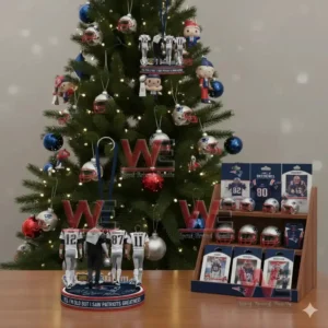 Alt text: A holiday scene with a Christmas tree featuring Patriots ornaments and figurines of famous Patriots players displayed on a table.