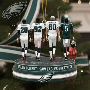 Four Eagles players on a circular ornament base in front of a decorated Christmas tree.