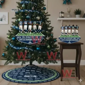 Alt text: A festive Christmas tree with Seattle Seahawks ornaments and a collection of figurines of Seahawks players displayed on a table.