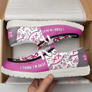 Pink and gray shoes with doodle graphics and text displayed inside an open box.
