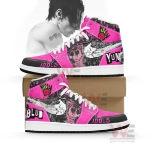 Pink and black high top sneakers with graphic artwork displayed on a brown box.