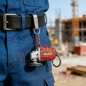 Small red grinder keychain hanging from a belt with construction background!
