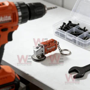 Red miniature grinder keychain placed near a drill and hardware tools!