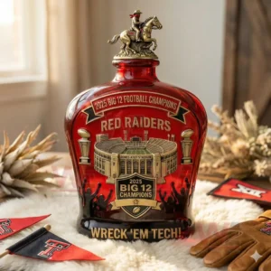 2025 Big 12 Championships Commemorative Edition Whiskey Bottle 5 A standing red championship bottle with surrounding team accessories on a wooden table!
