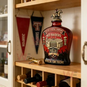 2025 Big 12 Championships Commemorative Edition Whiskey Bottle 7 A red championship bottle on a wooden shelf with wine bottles and team banners nearby!