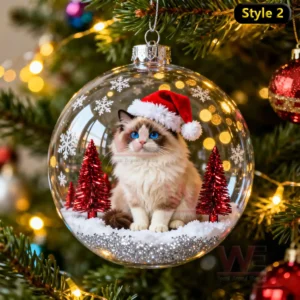 A blueeyed fluffy cat in a Santa hat inside a transparent ornament with red trees on a Christmas tree!