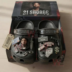 Black clogs in an open box with twenty one savage themed charms and a lid showing a portrait and name text.