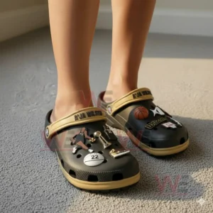 Clogs displayed on a soft floor with various sport charms attached to the upper surface!