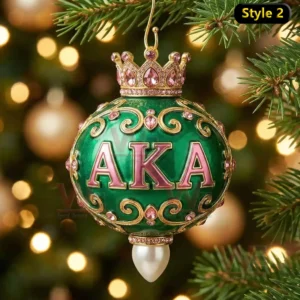 Green crowned ornament with gold and pink details hanging on a Christmas tree!