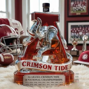 Crimson Tide themed letter A bottle with elephant sculpture surrounded by football collectibles!