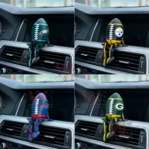 Four football shaped dashboard figures in green black blue and dark green colors sitting on a car air vent inside a vehicle!