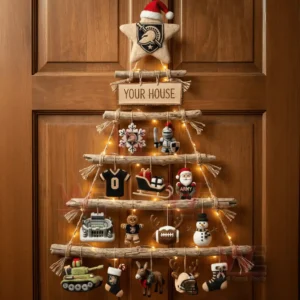 A rustic wooden branch Christmas wall tree decorated with Army Black Knights ornaments and warm lights hanging on a wooden door!