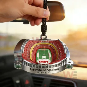 Arrowhead Stadium Farewell 3D Car Ornament 3 Hand holding an Arrowhead Stadium Chiefs hanging ornament with a three dimensional stadium bowl design green field center and engraved Arrowhead Stadium 1972 2030 text inside a car.