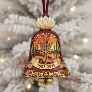 A close up of an Arizona State Sun Devils themed bell ornament with cactus and sunset imagery hanging in front of a white holiday tree!