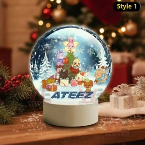 A snow globe showing adorable animals decorating a Christmas tree in a snowy forest with ATEEZ written on the base!