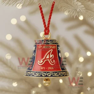 A close up of an Atlanta Braves anniversary bell ornament with gold patterns hanging on a Christmas tree!