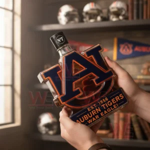 Hands holding an Auburn Tigers logo bottle with dark blue and orange colors in a cozy interior!