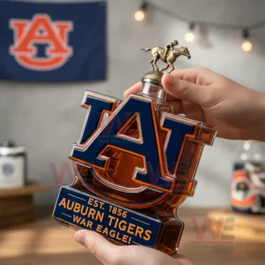 Auburn Tigers War Eagle Custom Whiskey Bottle 5 A hand holding an Auburn logo bottle with a decorative top and team flag behind!