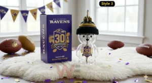 Baltimore Ravens 30th Anniversary 1996-2026 Bear Glass Cup 5 Clear bear shaped glass cup with Baltimore Ravens anniversary design displayed with a themed box and football props!