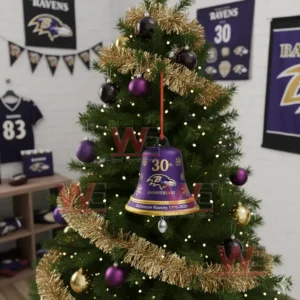 A purple Baltimore Ravens anniversary bell ornament with gold accents hanging on a decorated Christmas tree!