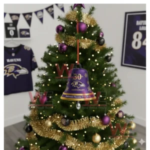 A purple and gold Baltimore Ravens anniversary bell ornament hanging on a Christmas tree!