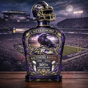 Purple and gold themed whiskey bottle with a raven emblem and football helmet cap displayed in a large football stadium at night!
