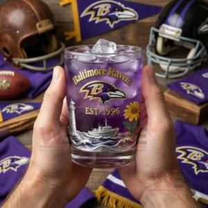 Baltimore Ravens Play Like a Raven Whiskey Glass 3 Hands holding a Baltimore Ravens whiskey glass with purple beverage ice cubes and football themed background!