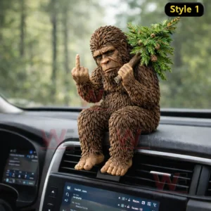 Bigfoot figurine sitting on a car dashboard holding a pine branch with forest background visible outside the vehicle!