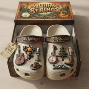 Beige Billy Strings clogs arranged in a wooden display box with music themed charms and a rustic design!