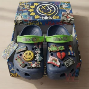 Navy clogs in an open blink one eight two themed box with green straps and multiple music inspired charms.