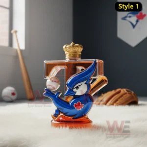 A crowned bottle with a blue jay figure holding a baseball placed on a soft white rug in an indoor sports space!